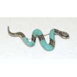 A silver marcasite and turquoise set snake brooch.