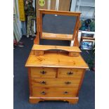 A 4-drawer pine dresser with mirror top