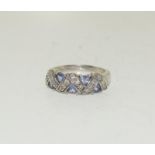 Hallmarked Tanzanite and Diamond cluster ring on hallmarked white gold.