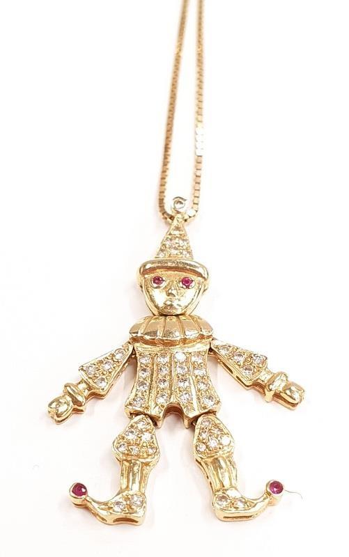 18ct gold diamond clown pendant with ruby eyes.