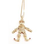 18ct gold diamond clown pendant with ruby eyes.