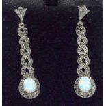 A pair of silver Marcasite and Opal paneled drop earrings of snake form.