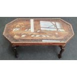 African carved coffee table with elephant legs and ivory inlay