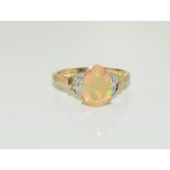 A 9ct gold pear shaped natural opal and diamond 9ct gold ring size N 1/2, 2.3grams