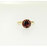 A 9ct gold ladies antique set garnet cluster ring, Size Q.