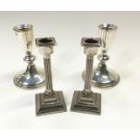 Pair of silver candlesticks together with a pair of Corinthian candlesticks.