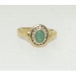 A 9ct gold ladies diamond and emerald ring, Size L 1/2.