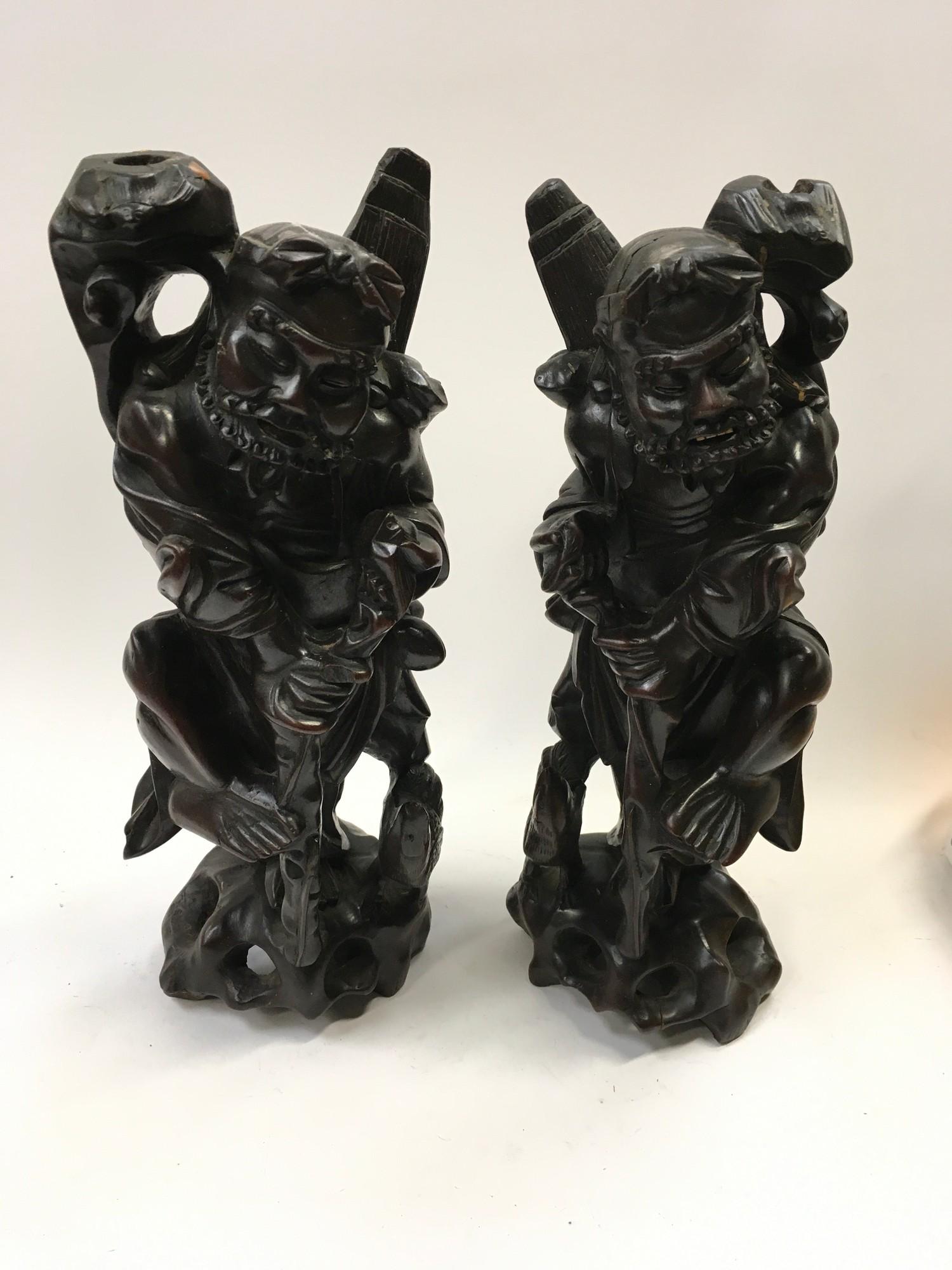 Pair of carved oriental peasant figures.