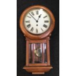 An oak cased wall hanging clock with pendulum.