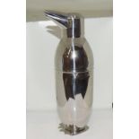 A novelty silver plated cocktail shaker in the form of a penguin.