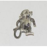 A silver and marcasite monkey brooch.