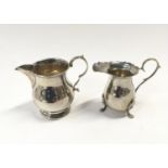 Two silver h/m cream jugs.