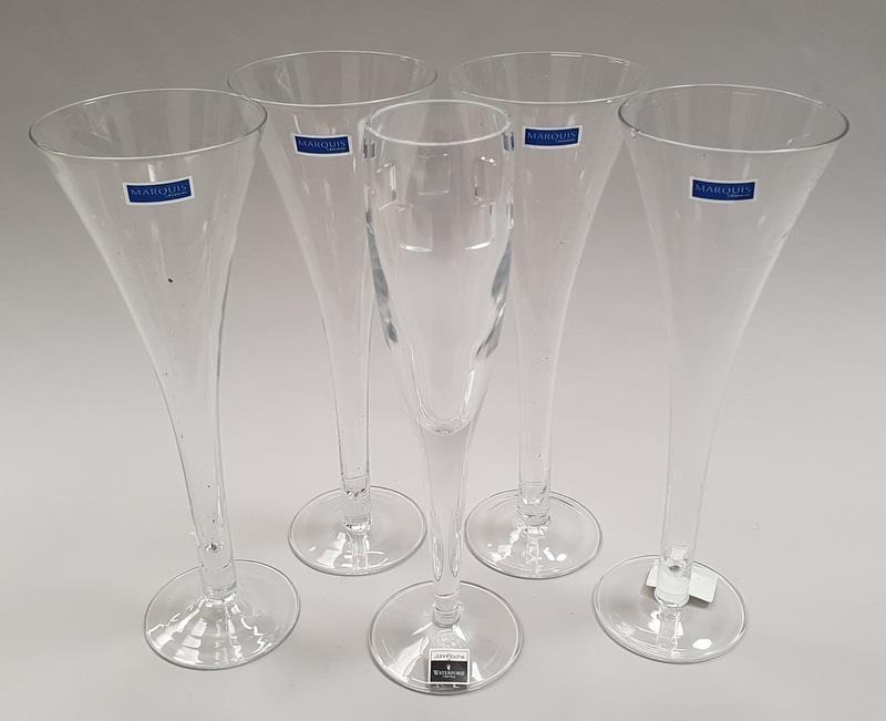 A set of four Marquis by Waterford fluted drinking glasses together with another by John Rocha at