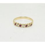 A 9ct gold ladies Diamond & Ruby 1/2 eternity Ring, Size O.