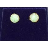 A pair of gold opal stud earrings.