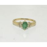 A 9ct gold ladies emerald and diamond shoulder ring, Size P.