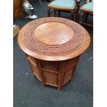 Octagonal ebonised and inlaid oriental table.