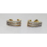 A pair of 18ct gold triple row diamond half hoop earrings, 10.7gms.