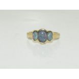 A 9ct gold opal trilogy ring. Size O.