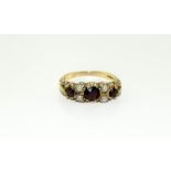 A 9ct gold ladies antique set garnet and pearl ring, Size Q.