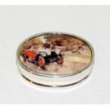 A silver and enamel pill box depicting a vintage car.