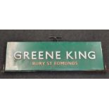 A pub sign 'Greene King'.