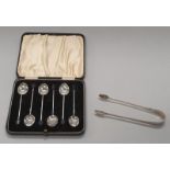 Boxed silver coffee bean spoons together with Georgian silver sugar tongs.