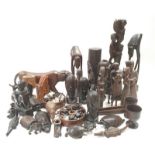 A large collection of tribal African wooden carvings depicting animals, people and other items.