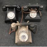 Three vintage Bakelite telephones.