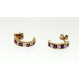 A pair of 9ct gold diamond and ruby earrings.