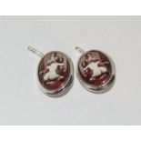 A pair of silver and enamel cuff links depicting a nude scene.