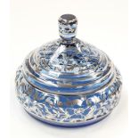 A large round lidded dressing table pot with silver decoration