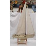 A model pond yacht with stand.
