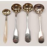 Four silver salt spoons one with Mother of Pearl handle and the other 3 gold plated bowl.
