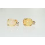 A pair of 9ct yellow gold opal and diamond stud earrings.