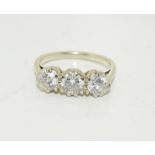 An 18ct white gold three stone diamond ring, Approx 1ct, Size O.