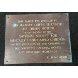 A large brass plaque tablet unveiled by The Queen Mother.