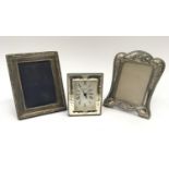 Silver photo frame together with another photo frame and a silver clock.