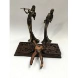 Carved wooden book slide, carved wooden nut crackers and pair of modern figures.