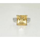 An 18ct Citrine 0.5ct/0.36ct diamond ring, size K.5