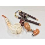 Carved meerschaum pipe and an alpine smoking pipe.
