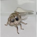 An unusual silver plated bee shaped honey pot.