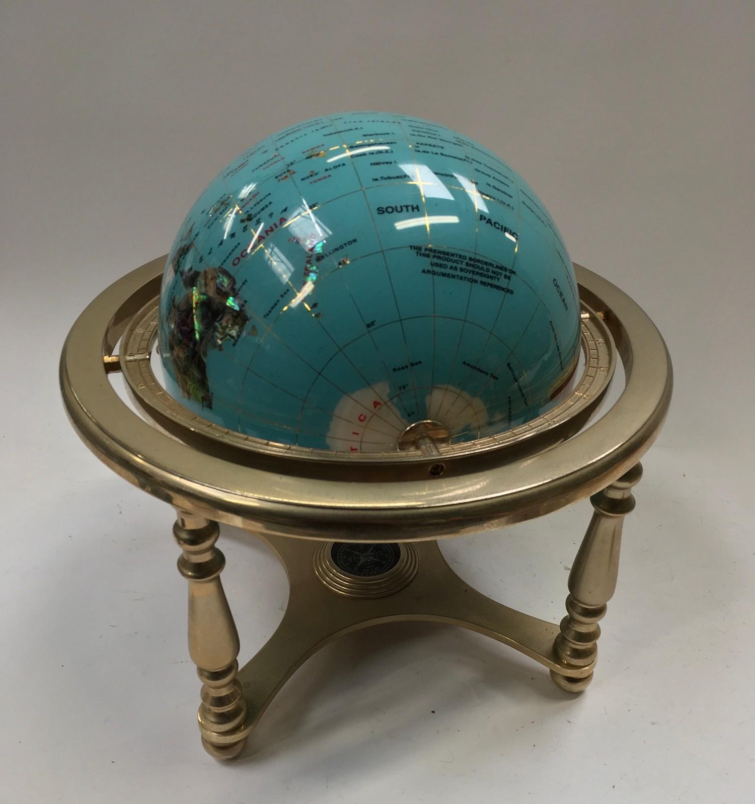 Table top globe with inset semi presious stones.