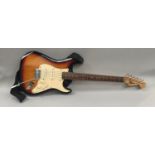 SQUIRE STRAT ELECTRIC GUITAR. This is made by Fender and has the Sunburst finish with maple neck.