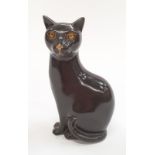 Poole Pottery unusual dark brown glazed cat with gold decorated eyes 6.5" high.