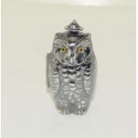 A silver plated owl shaped sovereign and half sovereign case.