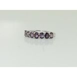 A 9ct white gold seven stone amethyst, Size K.