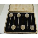 Boxed set of silver coffee bean spoons.