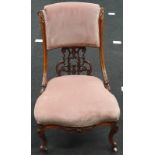 Victorian walnut nursing chair on porcelain castors with velour fabric.