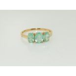 14ct gold ladies Zambian emerald trilogy ring. Size W+.